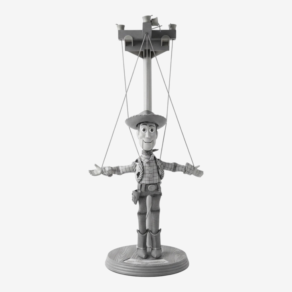 Once Upon Magic Woody marionette, a collectible featuring the iconic cowboy character from Toy Story with his signature hat, vest, and boots, displayed on a base.