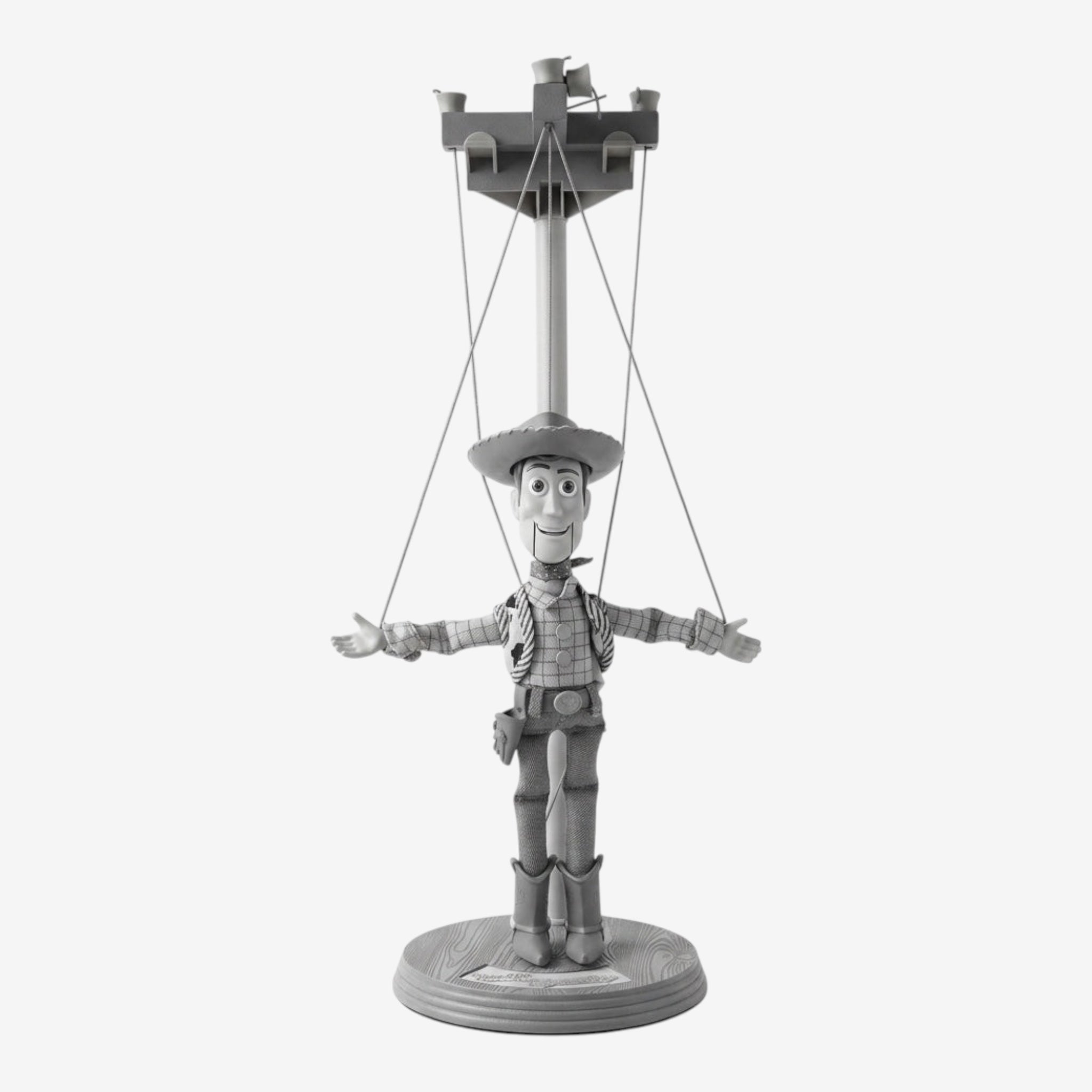 Once Upon Magic Woody marionette, a collectible featuring the iconic cowboy character from Toy Story with his signature hat, vest, and boots, displayed on a base.
